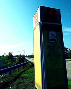 Information sign on field against clear blue sky