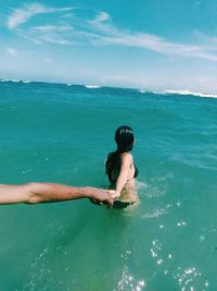 Full length of shirtless man swimming in sea