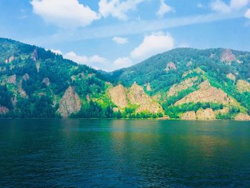 Scenic view of lake and mountains against sky