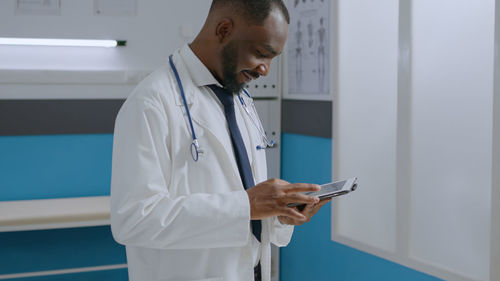 Female doctor using mobile phone