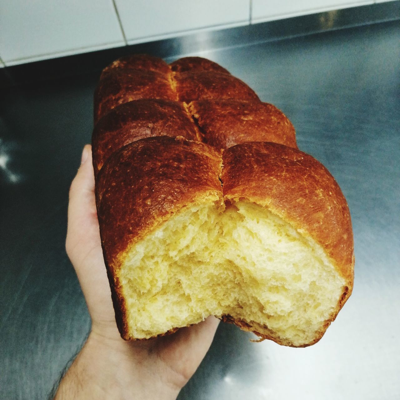 CLOSE-UP OF PERSON HOLDING BREAD