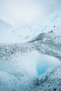 Glacier against cloudy sky