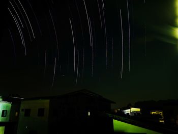 Illuminated building against sky at night