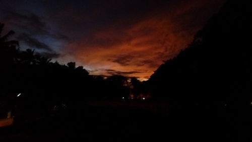 Silhouette of trees against sky at dusk