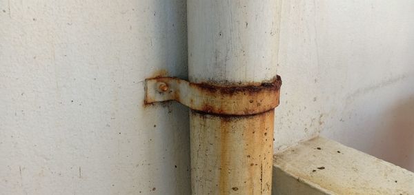 Close-up of rusty pipe against wall