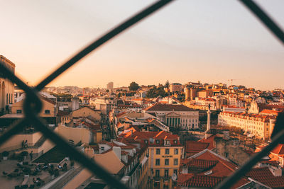 High angle view of city buildings against clear sky during sunset