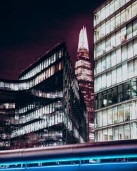 Low angle view of skyscrapers lit up at night