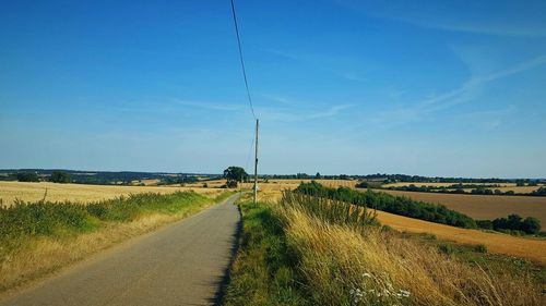 Dirt road passing through field