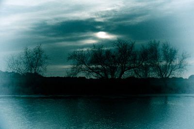 Scenic view of lake against cloudy sky