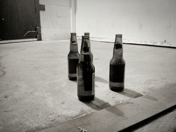 Close-up of beer bottles on floor