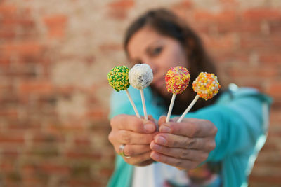 Close-up of woman holding lollipops