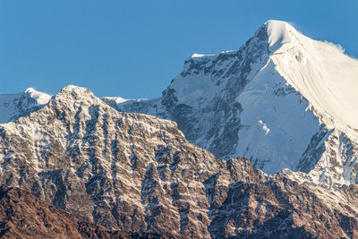 Scenic view of snowcapped mountains against clear sky