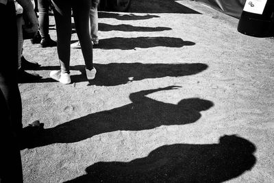 Shadow of people standing in queue