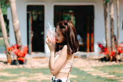 Portrait of young woman standing outdoors