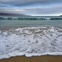 Scenic view of sea against cloudy sky