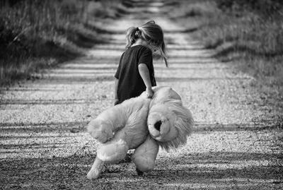 Woman with dog walking on field