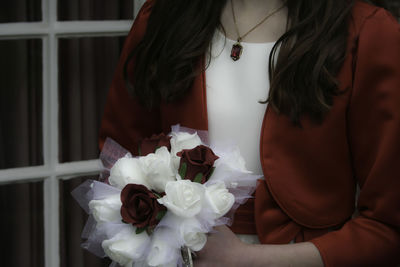 Close-up of woman with red roses