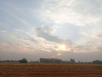 Scenic view of field against sky during sunset