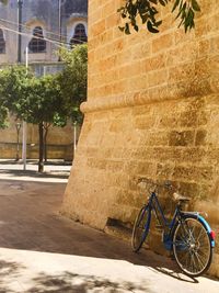 Bicycle against building in city