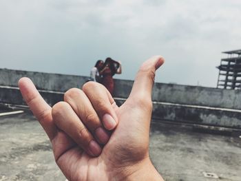 Close-up of young man holding hands over water