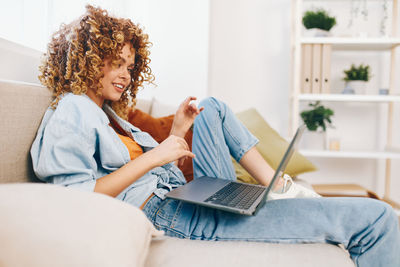 Young woman using laptop at home