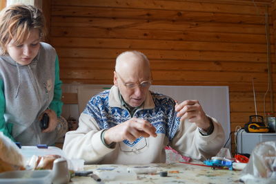 Portrait of friends sitting on table