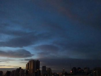 Cityscape against cloudy sky