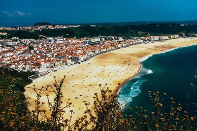 High angle view of townscape by sea against sky