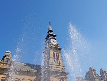 Low angle view of building against blue sky