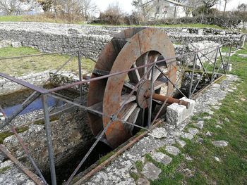 Old rusty wheel on field