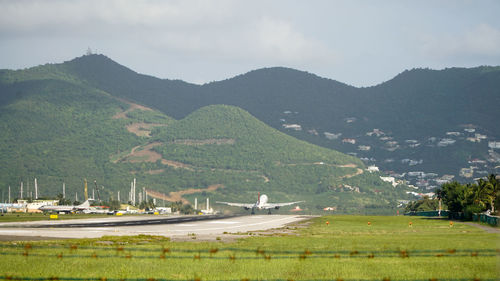 Scenic view of landscape and mountains against sky