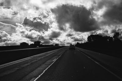 View of highway against cloudy sky