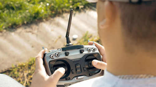 Cropped hand holding remote control