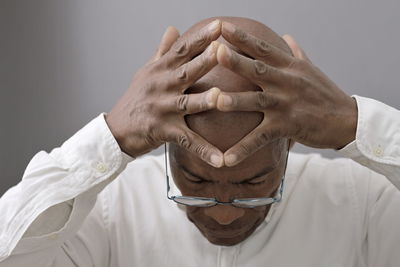 Midsection of man holding hands against white background