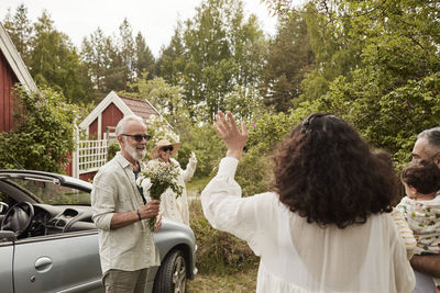 Family meeting near car