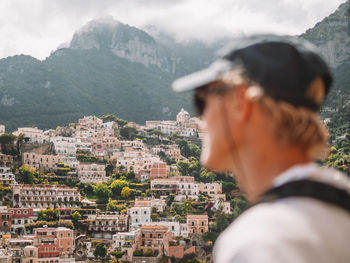 Close-up of man with townscape in background