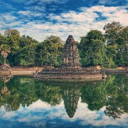 Old structure on lake against trees