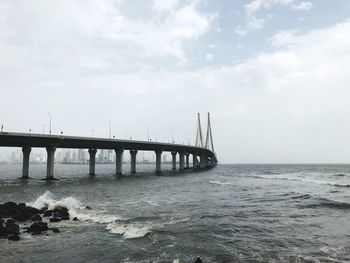 Bridge over sea against sky