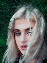 Close-up portrait of young woman with blond hair