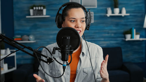 Portrait of young woman holding microphone