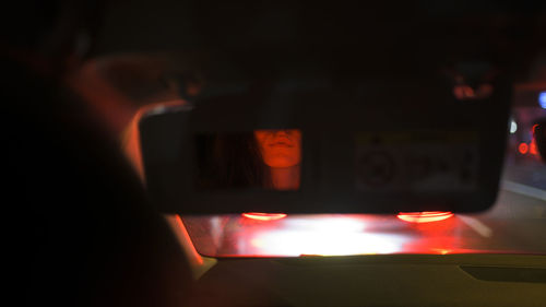 Close-up of lit candles in dark room