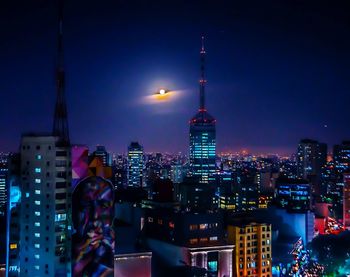 Illuminated buildings in city at night