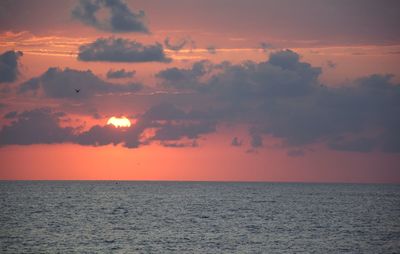 Scenic view of sea against orange sky