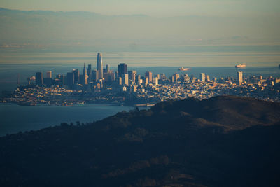 Panoramic shot of city by sea against sky