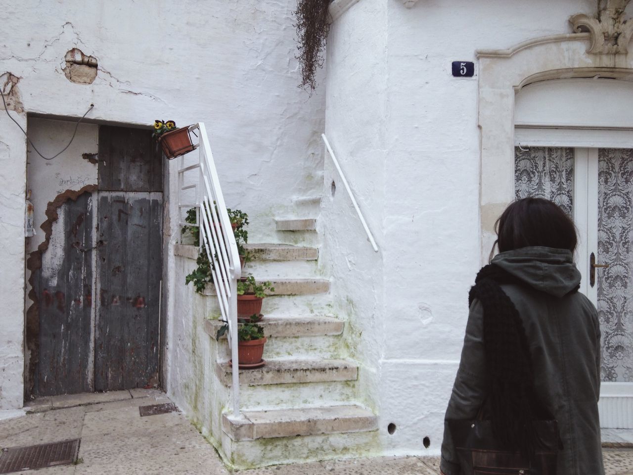 steps, built structure, architecture, staircase, building exterior, steps and staircases, men, railing, house, rear view, standing, lifestyles, building, day, wall - building feature, door, stairs, the way forward