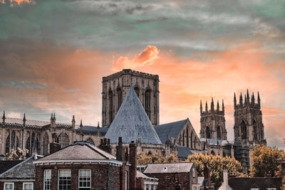 Buildings in city against sky during sunset