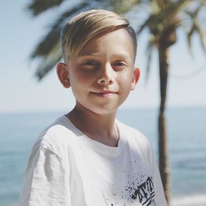 Portrait of boy standing in sea