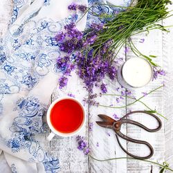 Directly above shot of tea with flowers and candle on table