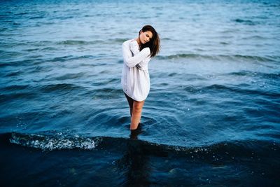 Portrait of young woman in water