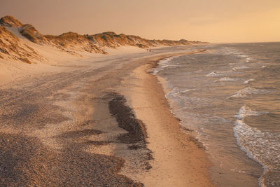 Scenic view of beach against sky during sunset